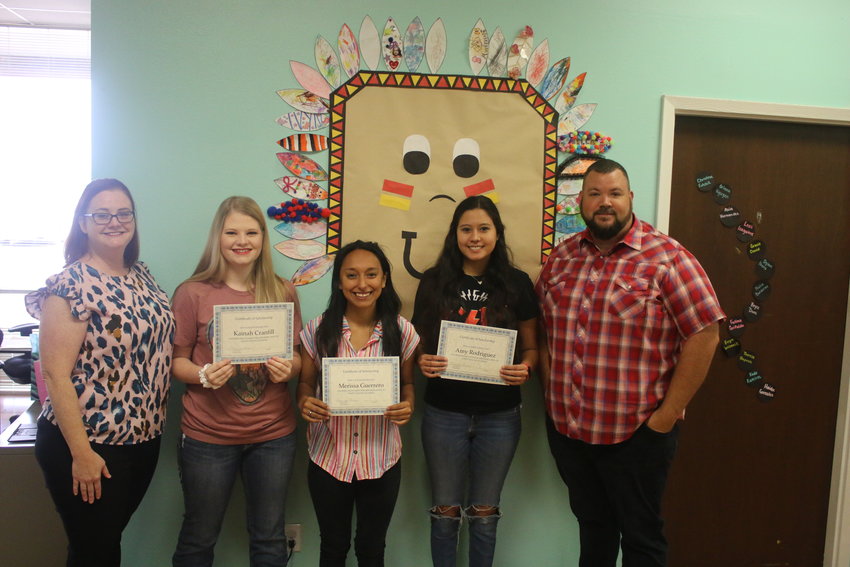 Happy Apache Academy owners Amanda Barrie, far left, and James Barrie, far right, presented certificates and scholarship checks to employees Kainah Cranfill, Merissa Guerrero and Amy Rodriguez on Friday, May 6.