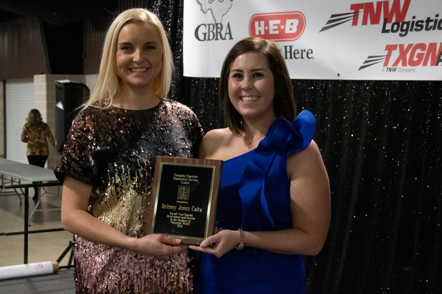 Community Service Award Winner recipient Britney Čaka poses with her Community Service Award and Gonzales Chamber of Commerce and Agriculture Executive Director Daisy Scheske Freeman.