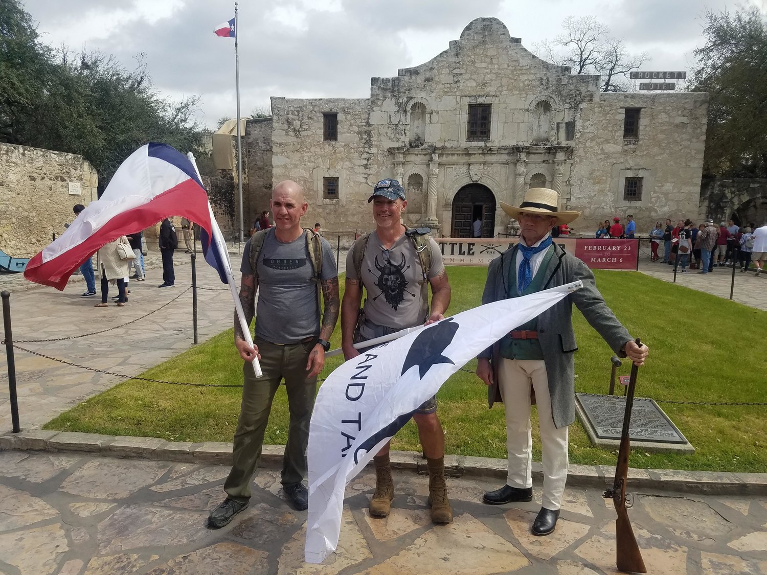 Terrence Ogden and Keith Busby of Wimberley, Texas walked 75 miles from Gonzales to the Alamo over the weekend to honor and commemorate the arrival of the Immortal 32. Terrence and Keith are seen holding the Come and Take It and Texas state flags.