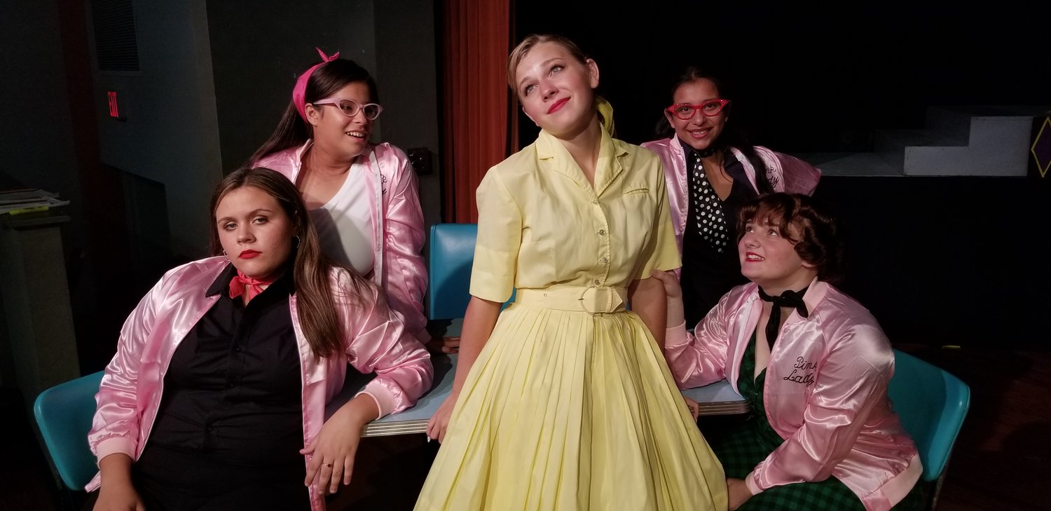 “Tell me more, tell me more!” said the Pink Ladies in the Apache Theatre Arts Department production of Grease, the school version. Pink Ladies are Haley Bairrington as Rizzo, Mary De La Garza as Marty, Sarah Cavender as Sandy, Sianna Ramirez as Jan, and Mary Heckendorf-Herd as Frenchy.