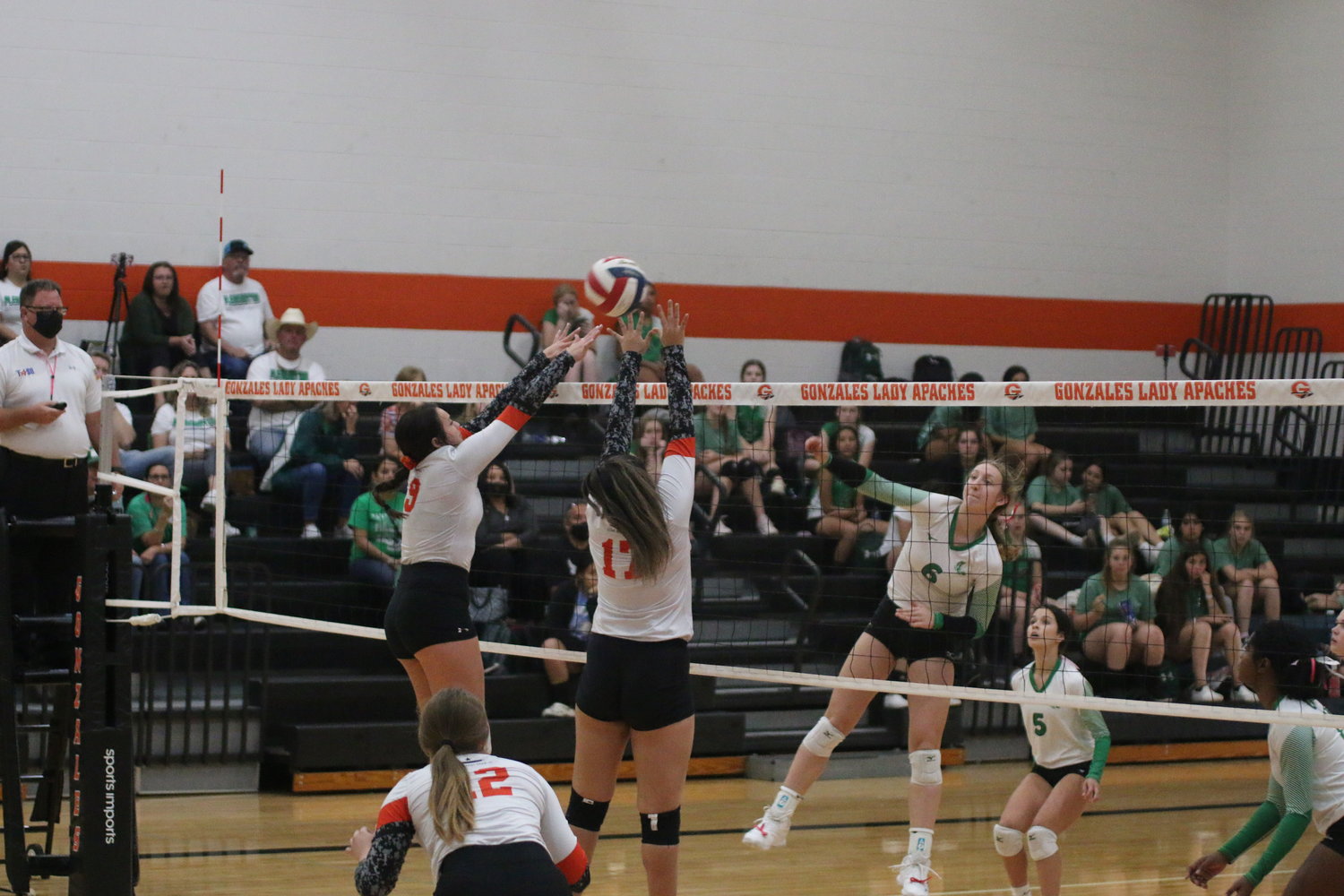 Kristyn Baker (9) and Marissa Molina (17) go up for a block against the Pleasanton Lady Eagles in the Friday, Oct. 8, contest. Macy Sample (12) waits to see the outcome.