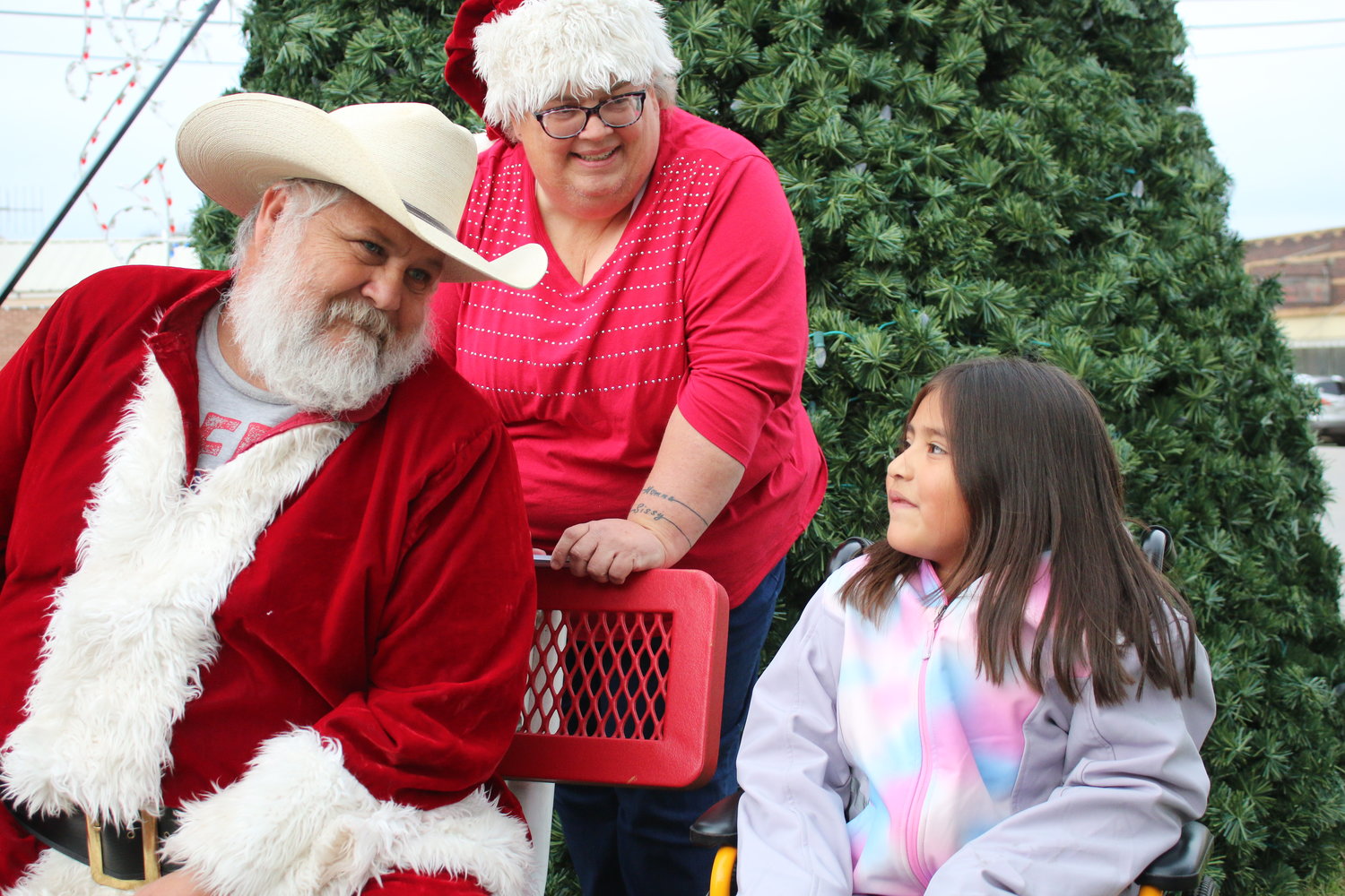 Santa Claus talks to Suraya Torres, 6, of Nixon, about what she wants for Christmas as Mrs. Claus listens during the Nixon Tree Lighting ceremony on Friday, Nov. 26.