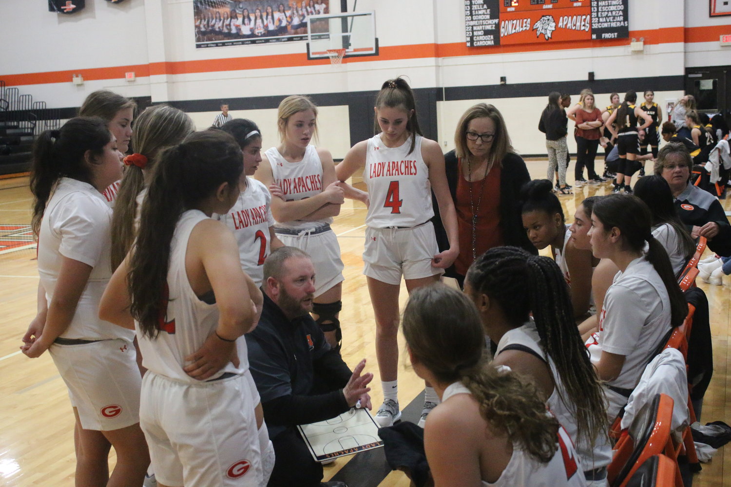 Coach Michael Fowler speaks to his team during a timeout against Sealy at home. The Lady Apaches lost to the Mathis Lady Pirates on Friday, Dec. 10, on the road.