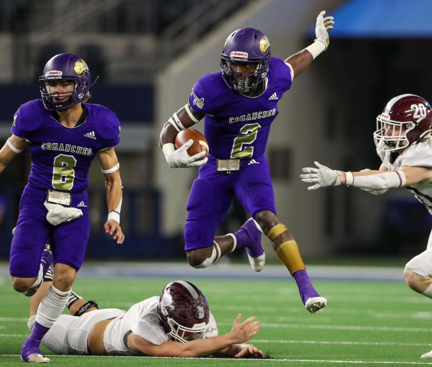 Shiner Comanches junior Dalton Brooks (2) hurdles a defender during the Class 2A Division I state football championship game between Shiner and Hawley on December 15, 2021 in Arlington, Texas.