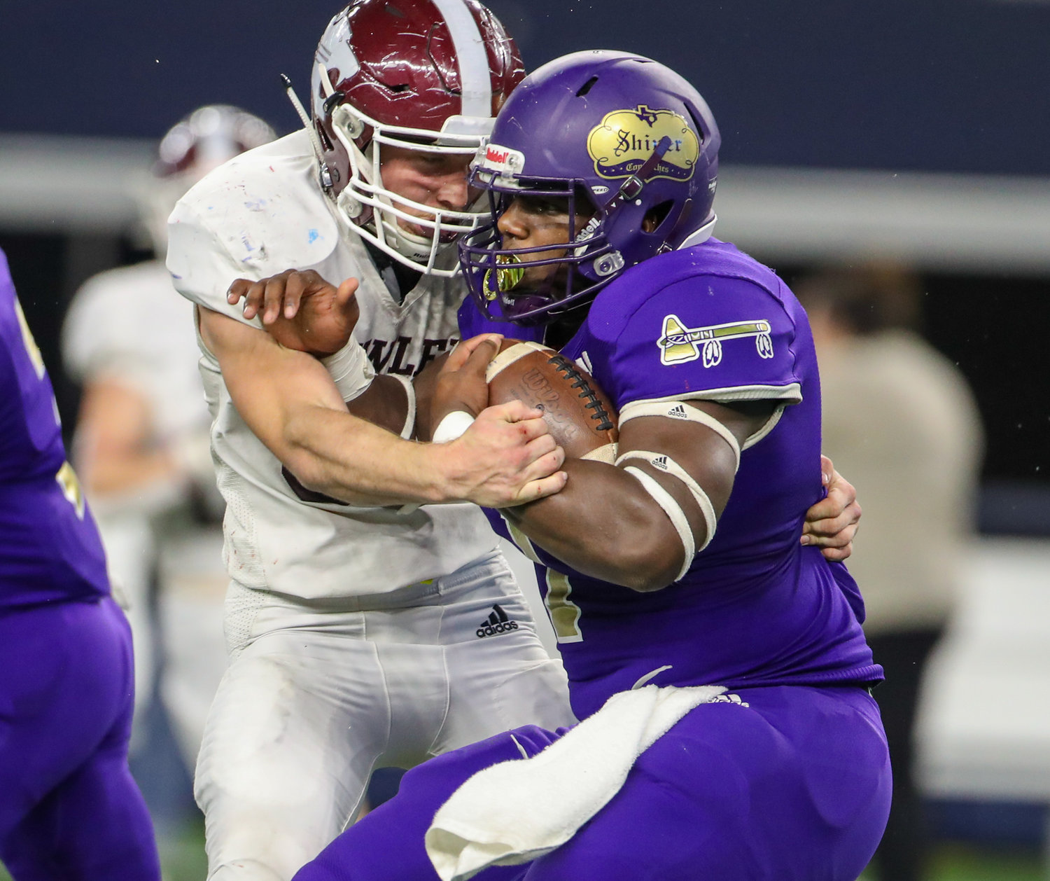 Shiner Comanches senior Doug Brooks (1) is wrapped up on a carry during the Class 2A Division I state football championship game between Shiner and Hawley on December 15, 2021 in Arlington, Texas.