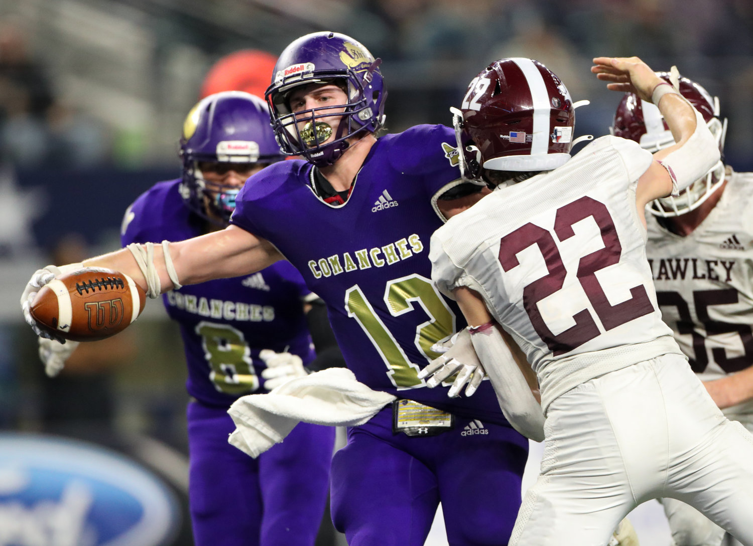 Shiner Comanches senior Tyler Bishop (12) extends the ball across the goal line for a touchdown during the Class 2A Division I state football championship game between Shiner and Hawley on December 15, 2021 in Arlington, Texas.