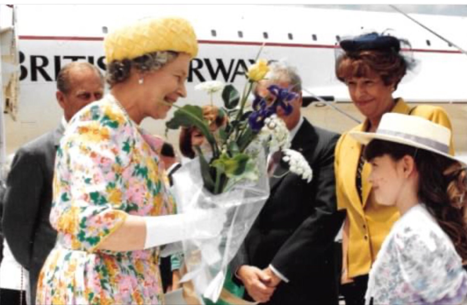 Nine-year-old Loren Ellison, who was born in Gonzales, greets Queen Elizabeth II with flowers at Bergstrom Air Force Base in Austin during the royal's May 1991 visit.