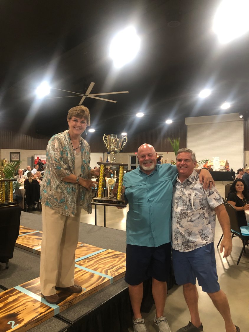 GHS Foundation president Carolyn Orts, left, presents the first place trophy to the duo of Gene Kridler and Darren Schauer during the 5F Gala at JB Wells Expo Center on Saturday, Sept. 18.