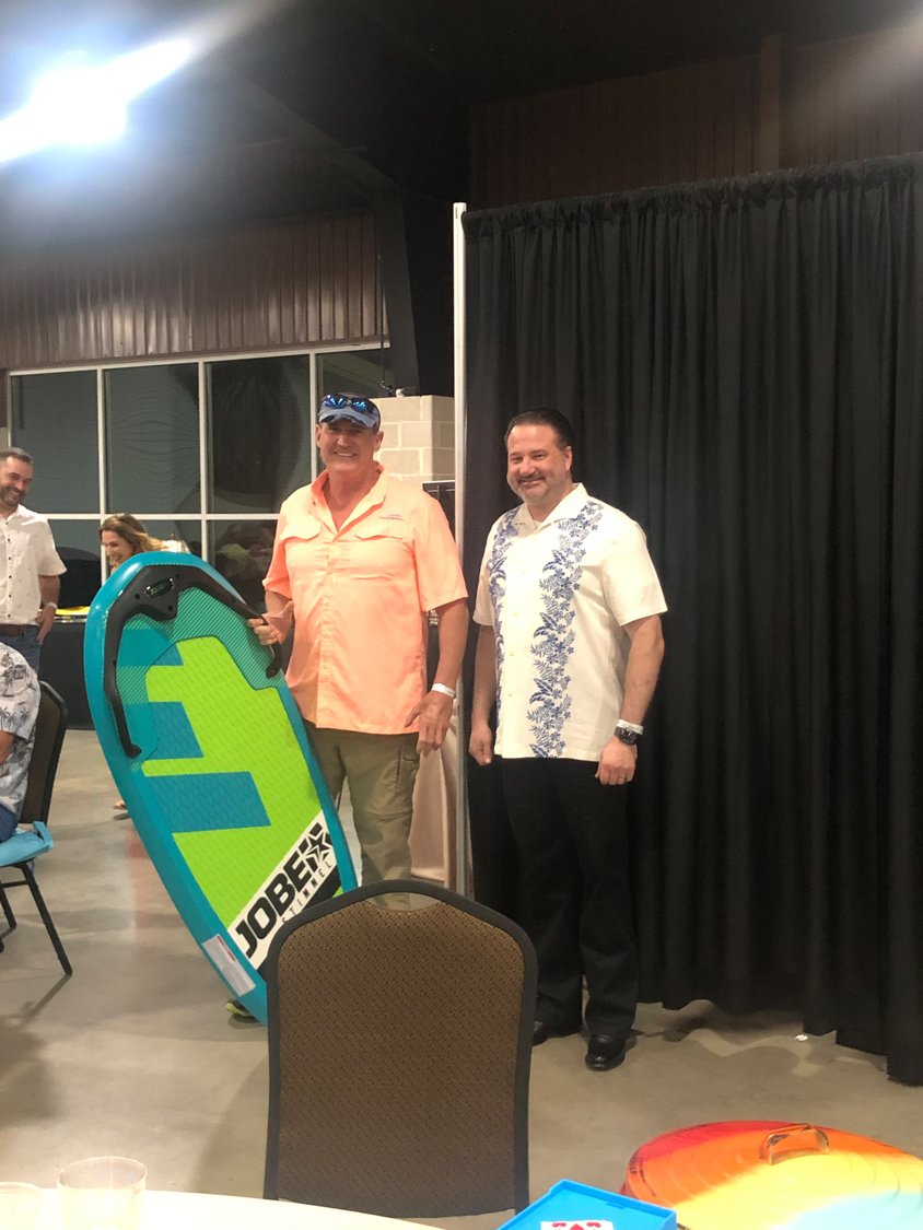 GHS chief executive officer Michael La Coste, right, presents a Jobe kneeboard to Tony Powers during the 5F Gala at JB Wells Expo Center on Saturday, Sept. 17.